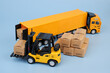 Container carrier truck and forklift truck with many carton boxes on blue background. Cargo and logistics concept.