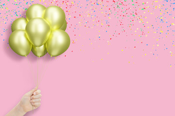 Aufkleber - Female hand holding bunch of shiny golden or yellow balloons on pink background with confetti. Empty space for text
