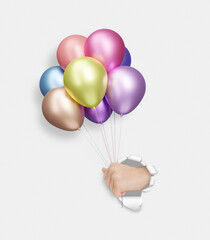 Poster - Childrens hand holding shiny colorful matte balloons through the hole in yellow paper