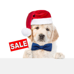 Sticker - Funny Golden retriever puppy wearing santa hat and tie bow shows signboard with labeled 