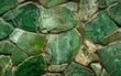 Overlapping green stone shards form a dense mosaic texture.