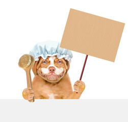 Sticker - Happy Mastiff puppy wearing shower cap with cream on it face holds empty placard above empty white banner. isolated on white background