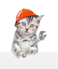 Poster - Cute kitten wearing hardhat holding adjustable wrench and looking above blank white banner. Isolated on white background