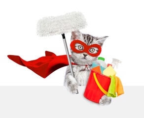 Poster - Cute kitten wearing superhero costume holds bucket with washing fluids and swab above blank white banner. Isolated on white background