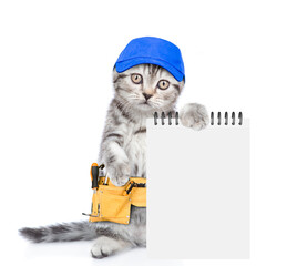 Poster - Funny cat wearing blue cap and toolbelt holds notepad.  Isolated on white background