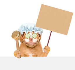 Poster - Mastiff puppy with shower cap on it head with pieces of cucumber on it eyes and with cream on it face holding blank banner mock up on wood stick above empty white banner. isolated on white background