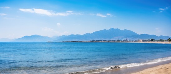 Poster - sea bay with mountains on background and blue sky copy space