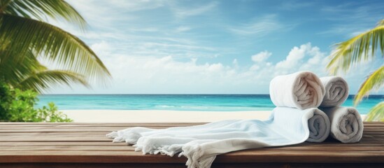 Poster - Summer decoration of towel and beach tools on wooden brown desk and landscape of ocean and beach Free space for your decoration. copy space available