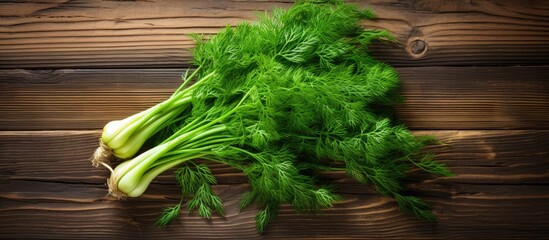 Poster - a bunch of green dill on a wooden background with blank space for text concept of fresh vegetables and healthy food. copy space available