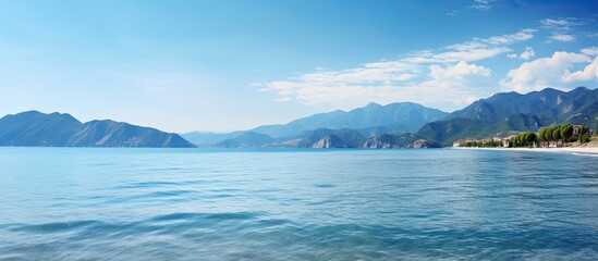 Poster - sea bay with mountains on background and blue sky copy space