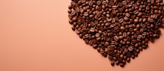 Aufkleber - Top view of a light orange background featuring a heart shaped pile of coffee beans providing ample copy space for text