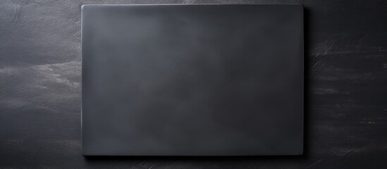 Poster - Empty square black plate over dark slate Aerial view with copy space