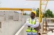 © JU.STOCKER - Engineer man at construction site, Foreman worker in hardhat standing with arms crossed at the precast concrete factory site