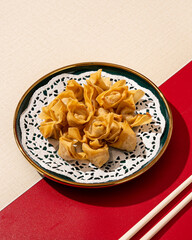 Wall Mural - Mini Dumplings are a traditional Chinese food in the form of minced meat wrapped in a sheet of fried wheat flour