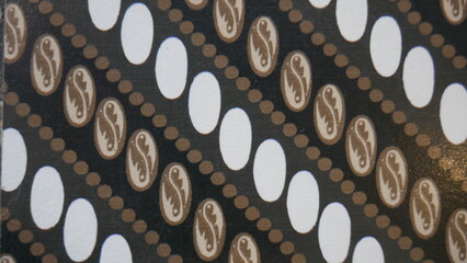 Poster - Fabric silk texture, brown and white with a pattern of circles. Texture, background, pattern. The fabric is black and white with a pattern of geometric figures.