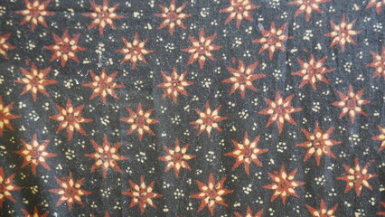 Poster - Close up of a colorful batik cloth pattern on black background.. Thai silk fabric pattern, Thai silk fabric pattern background.
