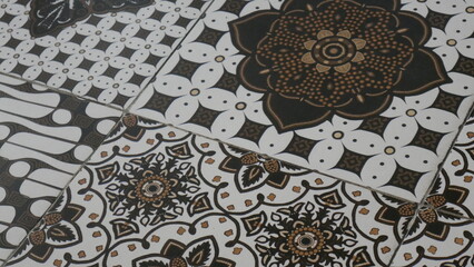Poster - Detail of traditional moroccan tiles with ornaments. a black and white floor with a design that says  flower. 