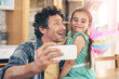 © peopleimages.com - Happy father, child and bonding with selfie for photography, picture or memory together at home. Little girl and dad with smile or costume for capture, moment or childhood in living room at house