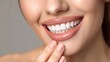 © marimalina - close-up of the lower half of a woman's face, highlighting her bright and cheerful smile, healthy white teeth and smooth, neutral-toned skin. Woman's lips painted with lipstick