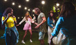 © ihorvsn - Many multi-ethnic young people dancing in backyard at party. Caucasian joyful girl and guy having fun outdoors. African American female dances with boy. Summer party celebration. Leisure concept