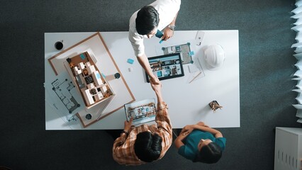 Poster - top view of skilled architect engineer working together and shaking hand cooperative team while maki