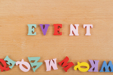 EVENT word on wooden background composed from colorful abc alphabet block wooden letters, copy space for ad text. Learning english concept.