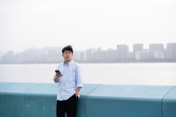 businessman using mobile phone in park