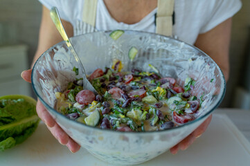 Wall Mural - Kidney bean salad with cucumber, tomatoes, onions, romaine salad with sour cream sauce in a bowl