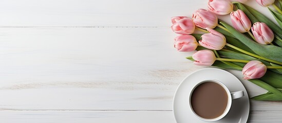 Wall Mural - A beautiful spring bouquet of five tulips on a white background paired with a cup of coffee creating a serene and inviting copy space image