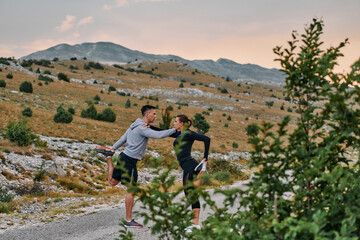 A Romantic Couple Stretching Down After a Run