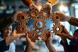 © VICHIZH - Group of people assembling wooden gears in circle with light in background, teamwork concept with cooperation and innovation