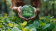 Green globe in the hands of a woman in the forest. Ecology concept