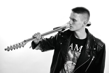 Rock musician with bass guitar and black leather jacket on a white background. Grain effect used