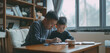 © Mongkol - A single dad helping his son with homework, emphasizing the support in their relationship, realistic photography,minimalist background, clean and simple setting, free space