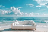 Fototapeta  - A white couch is sitting on the beach next to the ocean