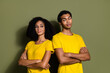 Portrait of two nice people folded hands look each other wear t-shirt isolated on khaki color background