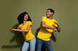 Portrait of two nice people enjoy music dance wear t-shirt isolated on khaki color background