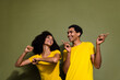 Portrait of two nice people good mood dancing wear t-shirt isolated on khaki color background