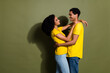 Profile portrait of two nice people cuddle empty space wear t-shirt isolated on khaki color background