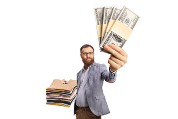 Wall Mural - Man with a pile of folded clothes smiling at camera and holding money