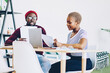 © BullRun - Young african american couple checking bills and receipts for paying online via application on laptop computer, dark skinned colleagues discussing ideas and making plans using modern technology