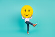 Full size photo of positive cheerful kid boy hide his face with smiley dancing rhythm isolated cyan color background