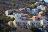 Fototapeta  - Symi Island, Greece. Greece islands holidays from Rhodos in Aegean Sea. Colorful neoclassical houses in bay of Symi. Holiday travel background