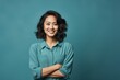 © Markus Schröder - Portrait of a glad asian woman in her 30s with arms crossed over soft blue background