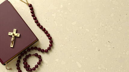 Wall Mural - Rosary beads and a prayer book on a light-colored surface, symbolizing faith and devotion.