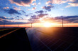 © Miha Creative - Solar panel generating green energy.Green energy reduce carbon emissions and makes earth cleaner and more ecological.Photovoltaic power station and wind turbines at sunset.