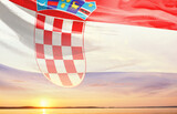 Fototapeta  - Croatia national flag waving in the sky.