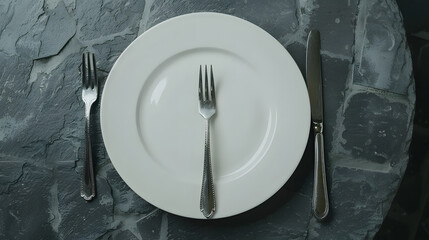 Poster - An empty white plate with a fork and a knife overhead flat lay shot on a slate background the concept of dinner : Generative AI