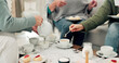 © peopleimages.com - Hands, tea party and senior friends in the living room of their home together for a visit during retirement. Wellness, relax and reunion with a group of elderly people sitting on a sofa in a house