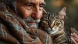 A man is holding a cat in his arms